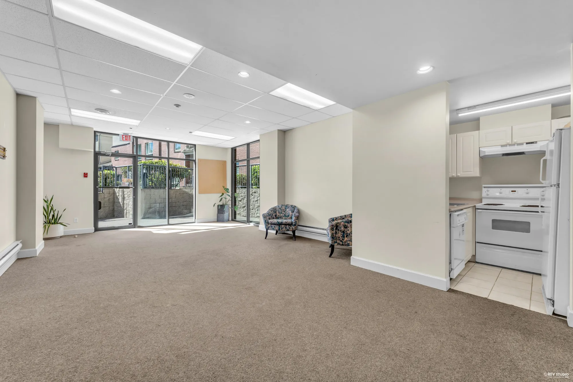 The shared amenity room with a kitchen at one end