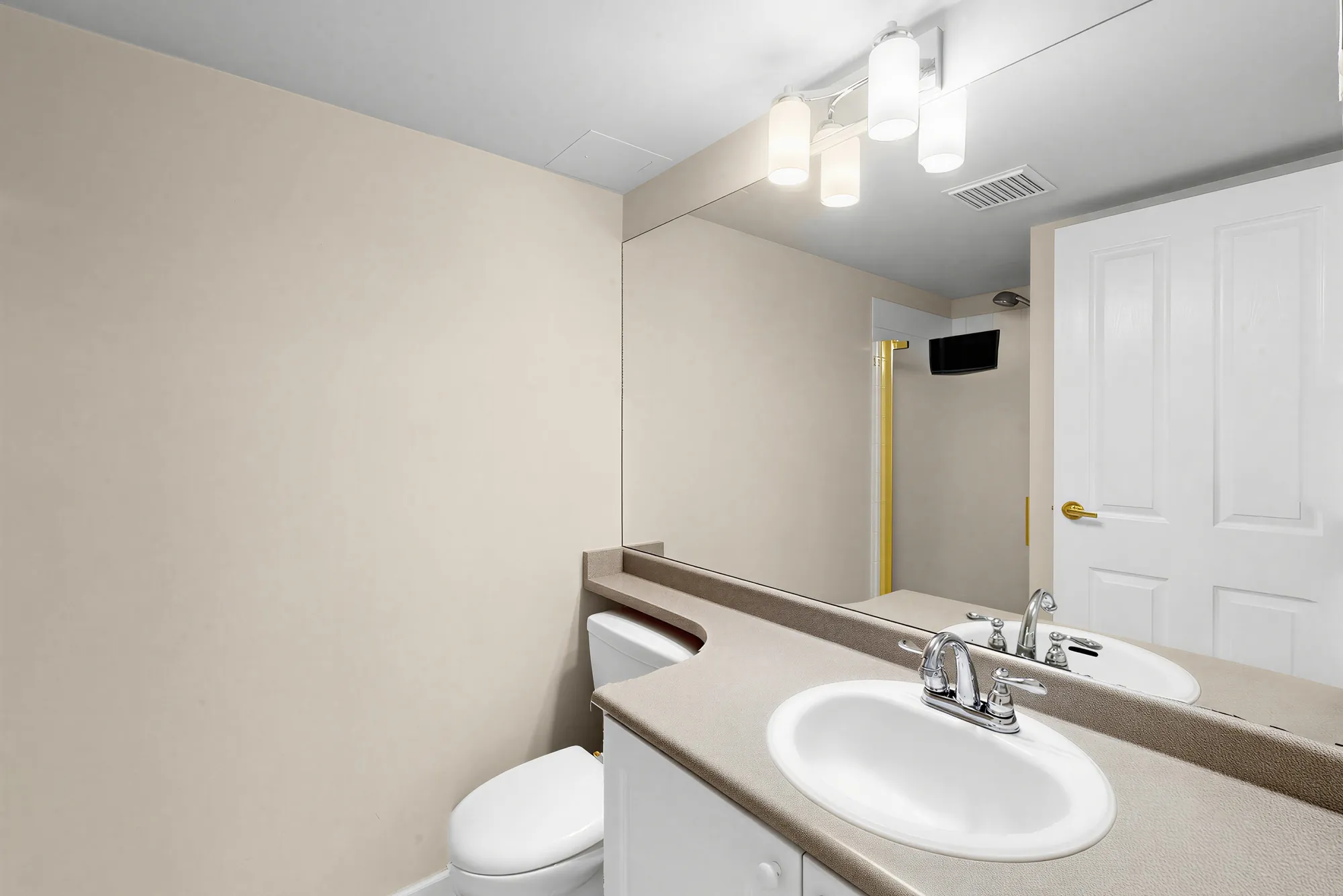 The second bathroom with a vanity and a shower stall