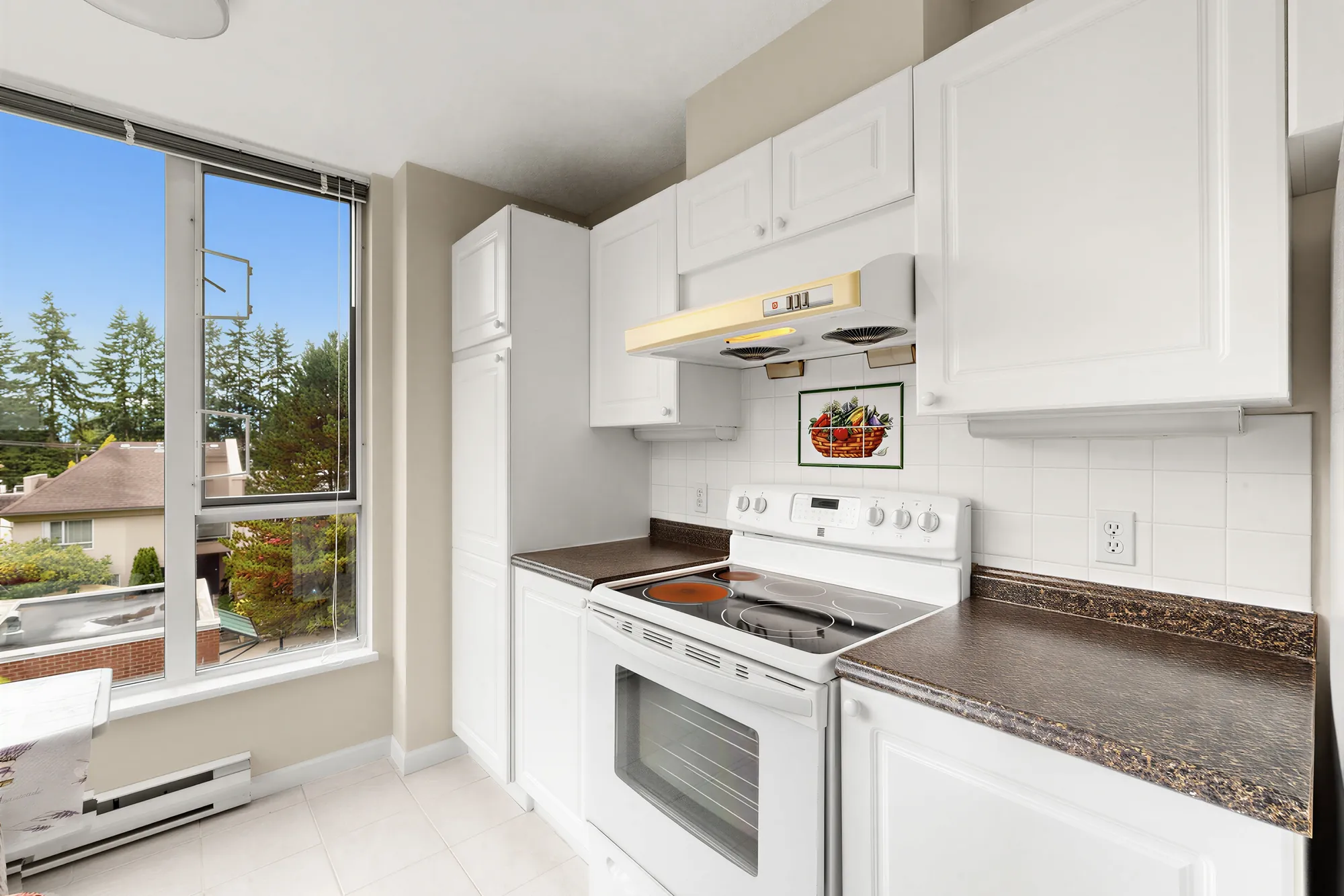 The range and hood with the window to the right