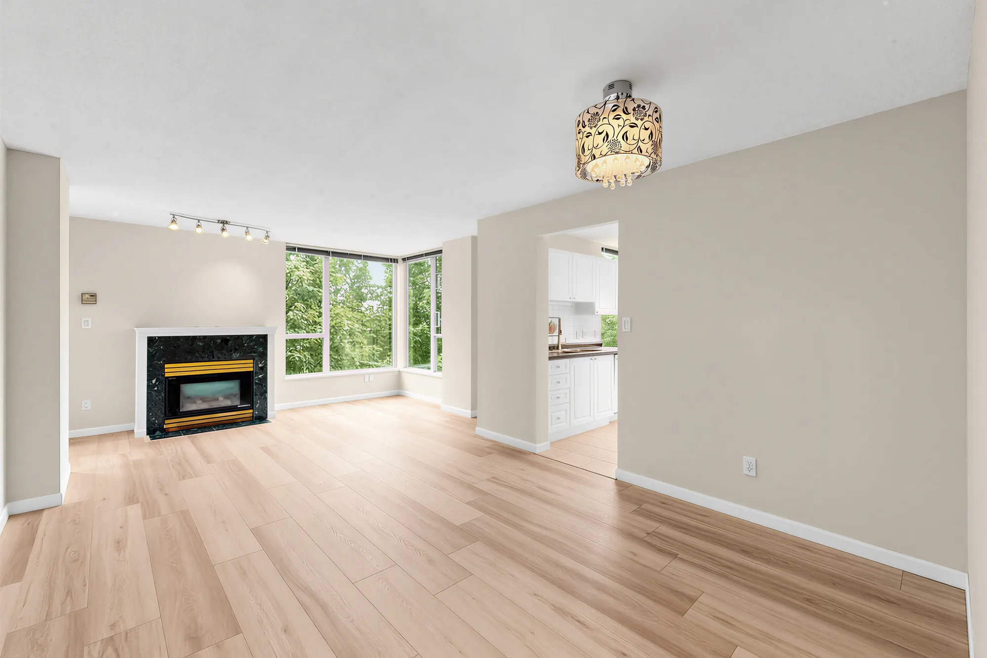 The living room corner with the gas fireplace and windows on two walls