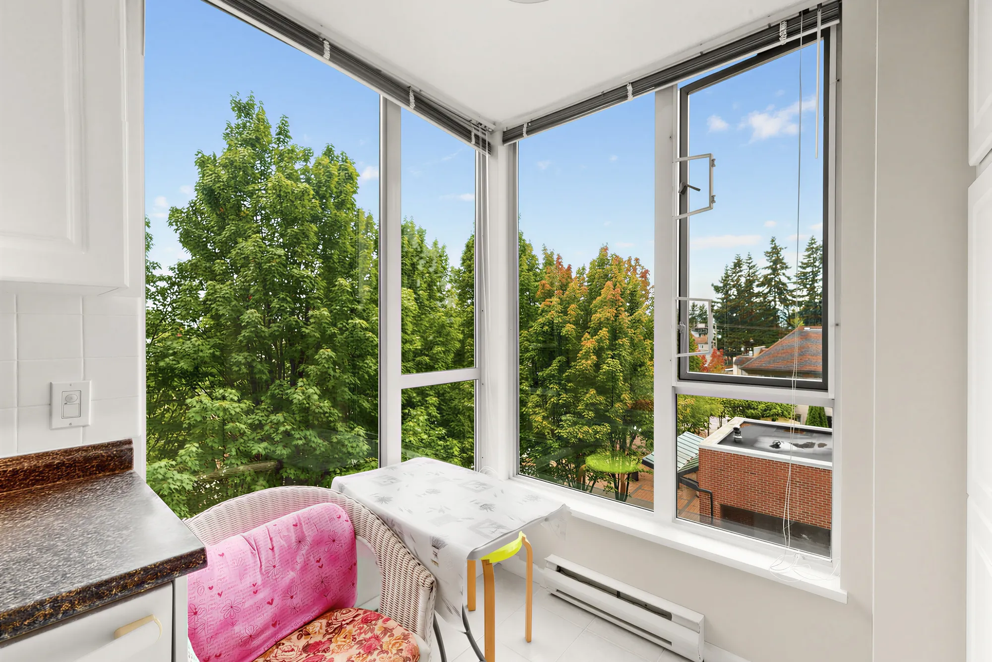 The window nook at the end of the kitchen counter, glass on two sides